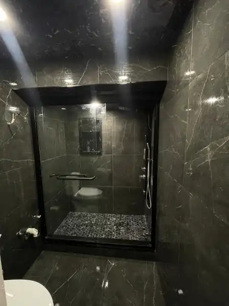 Custom marble-tile walk-in shower installed by Munir Pro Tiles in a Toronto bathroom renovation