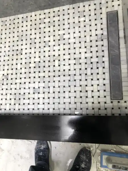 Glossy mosaic tile accent wall detail in a Munir Pro Tiles bathroom project