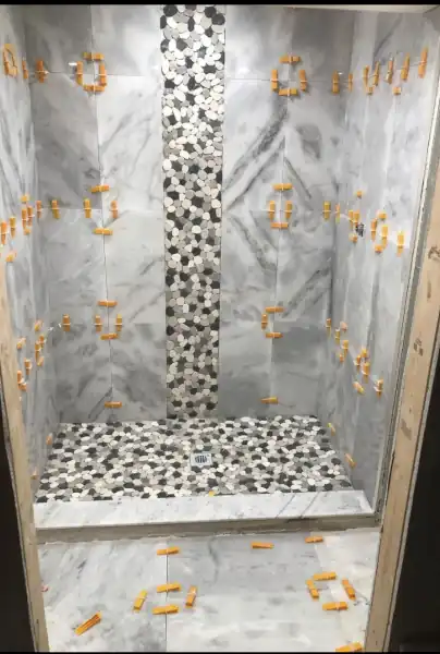 Marble tile shower installation in progress